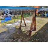 Vintage table with a glass top and smoked plastic trestle legs.