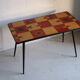 Vintage coffee table in laminate with geometric design, with tapered legs.