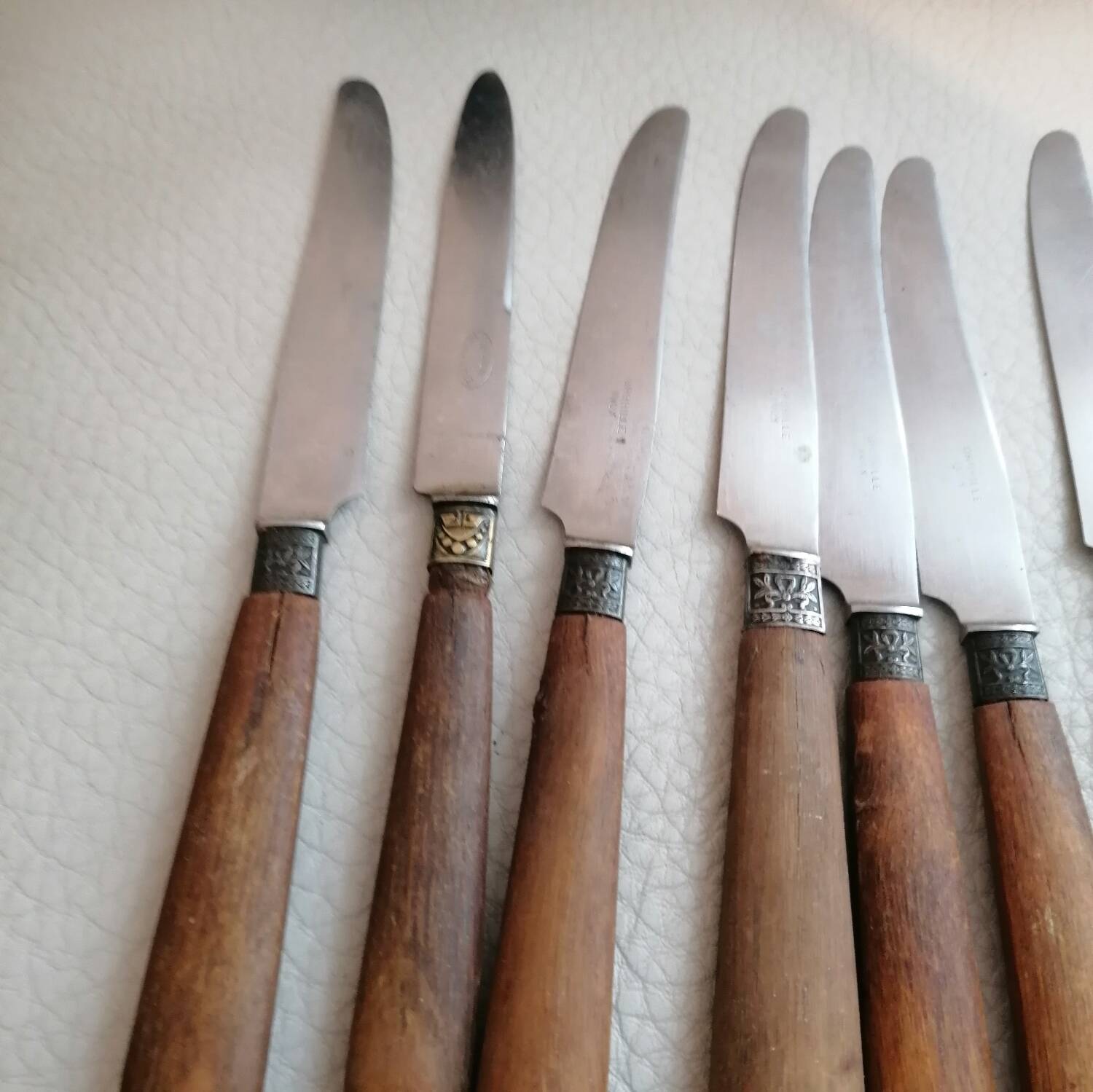 Old table knives and dessert knives, wooden handles, stainless steel blades