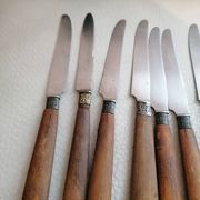 Old table knives and dessert knives, wooden handles, stainless steel blades