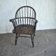Brown wooden Windsor chair, 19th century — slatted backrest and carved seat