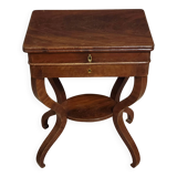 Empire writing table, in mahogany, resting on curved legs.