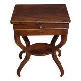 Empire writing table, in mahogany, resting on curved legs.