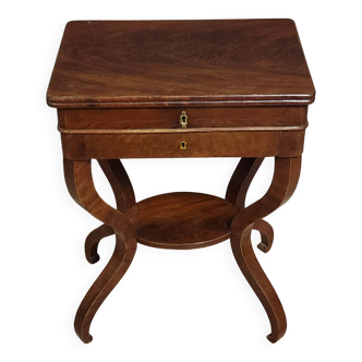 Empire writing table, in mahogany, resting on curved legs.