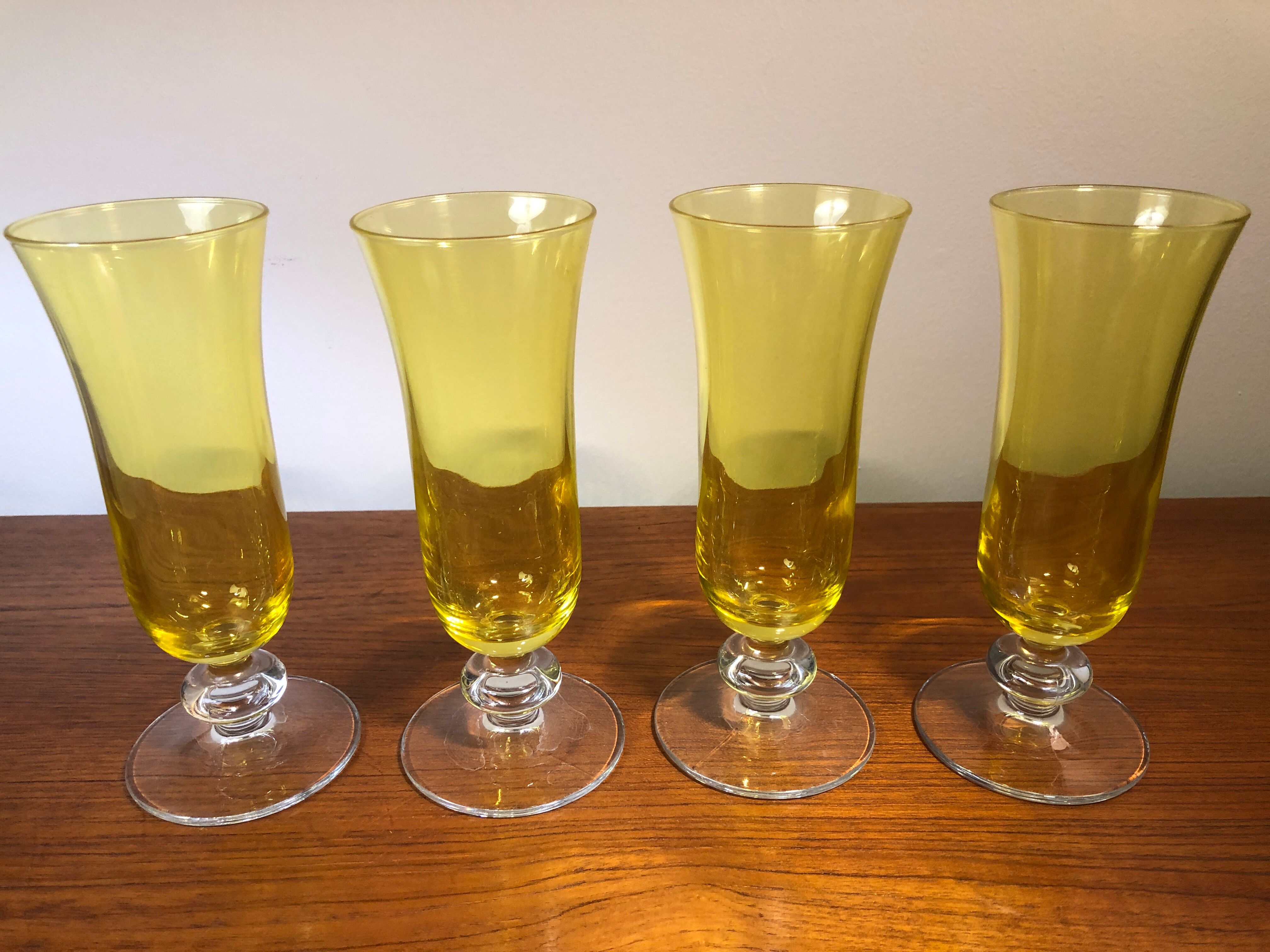Large transparent yellow champagne flutes