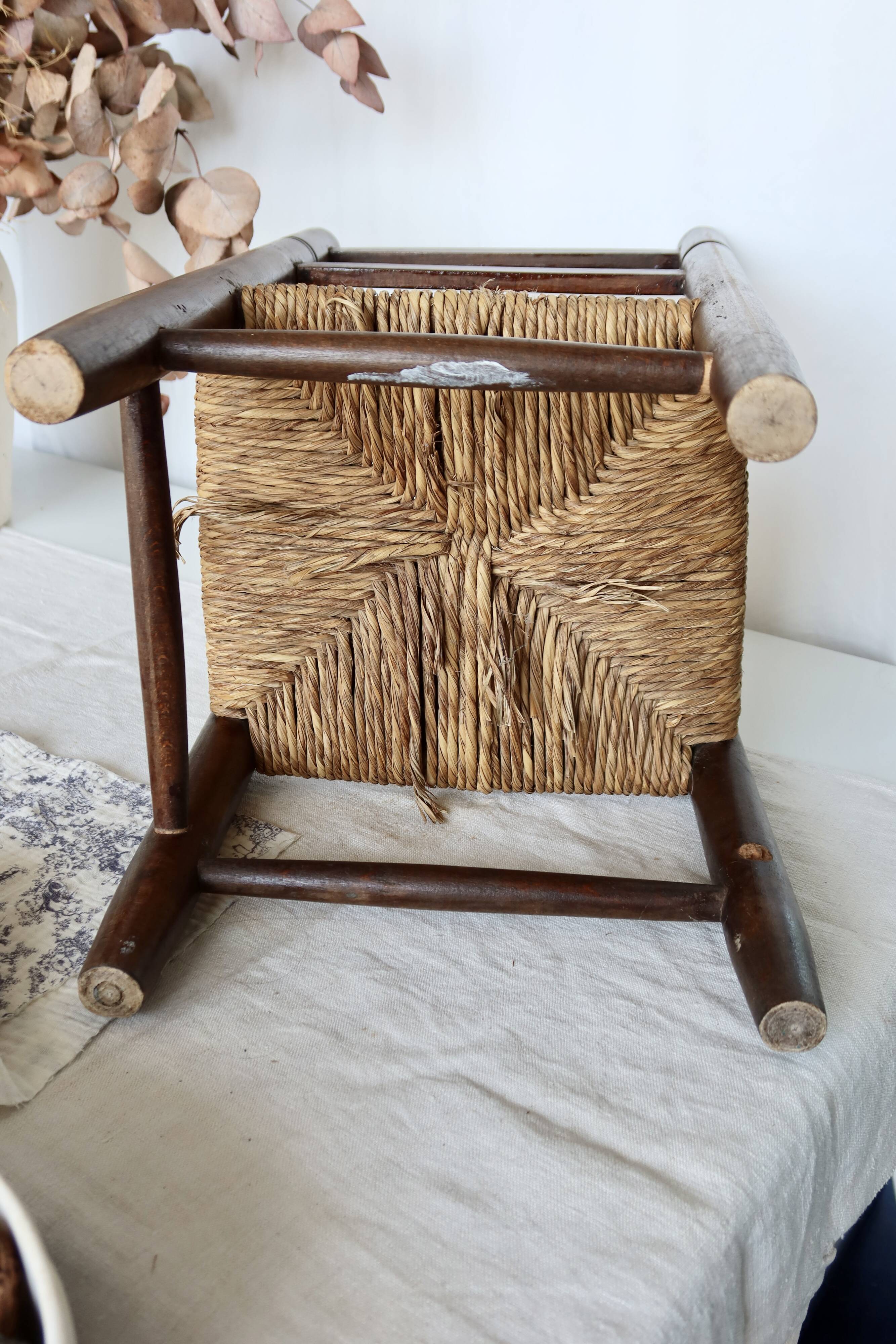 Vintage children's chair in dark wood with woven straw seat
