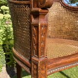 Fauteuil en bois fruitier et cannage style Louis XVl