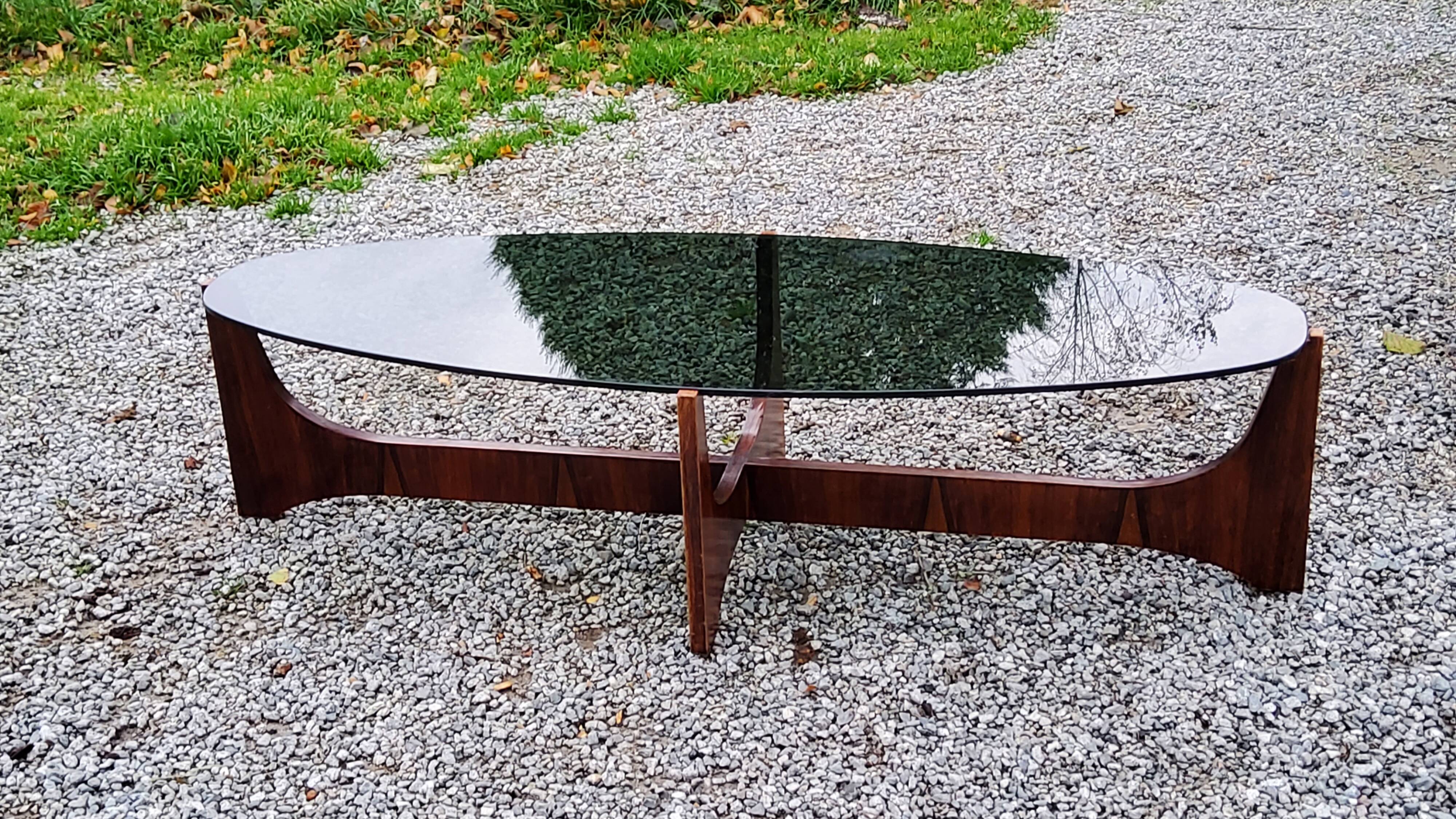 Designer coffee table by Hugues Poignant in rosewood and smoked glass from the 70s