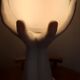70s lamp two hands embrace an opaline globe
