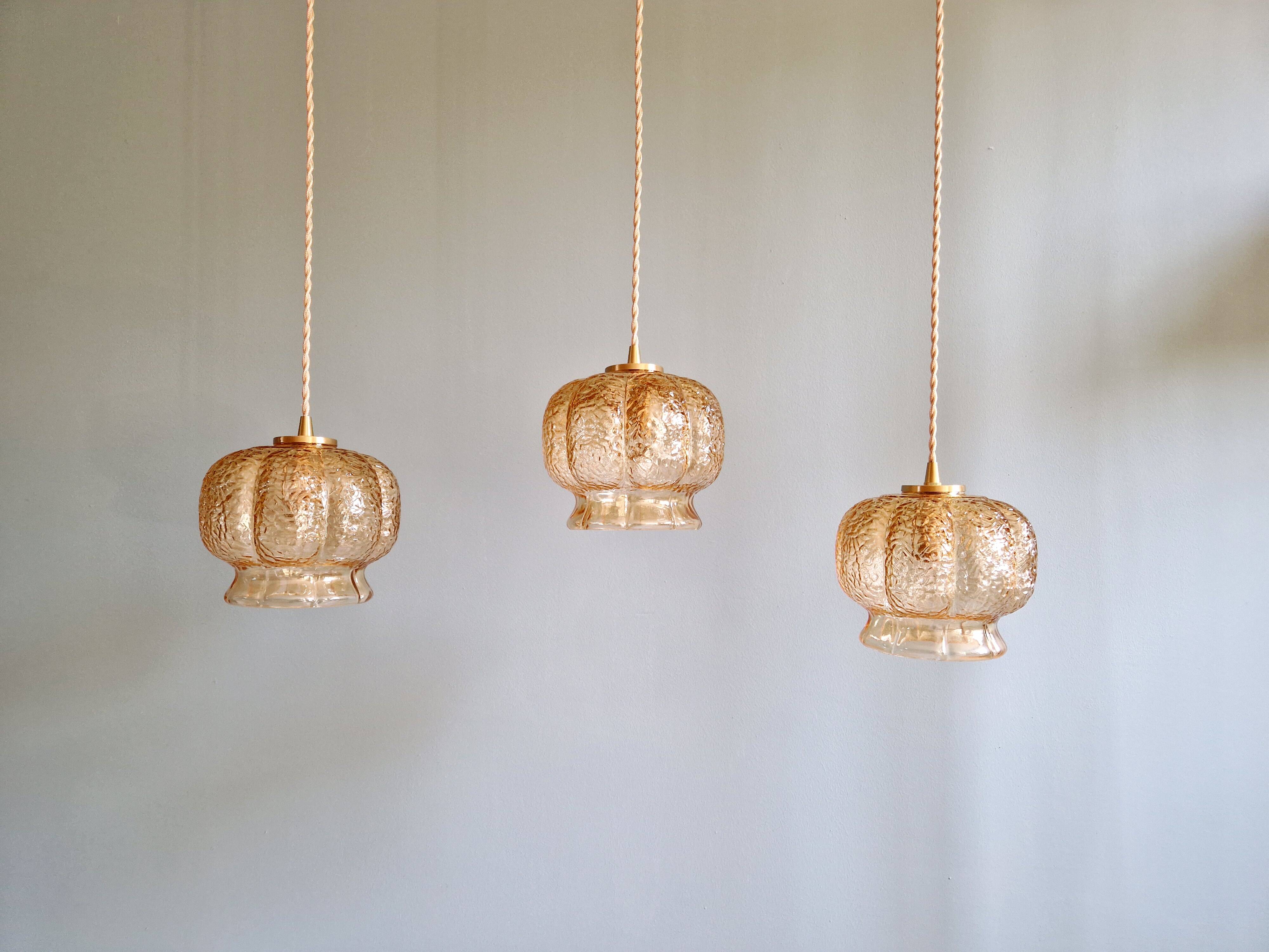 Vintage trio of amber glass pendants, 1960s-70s.