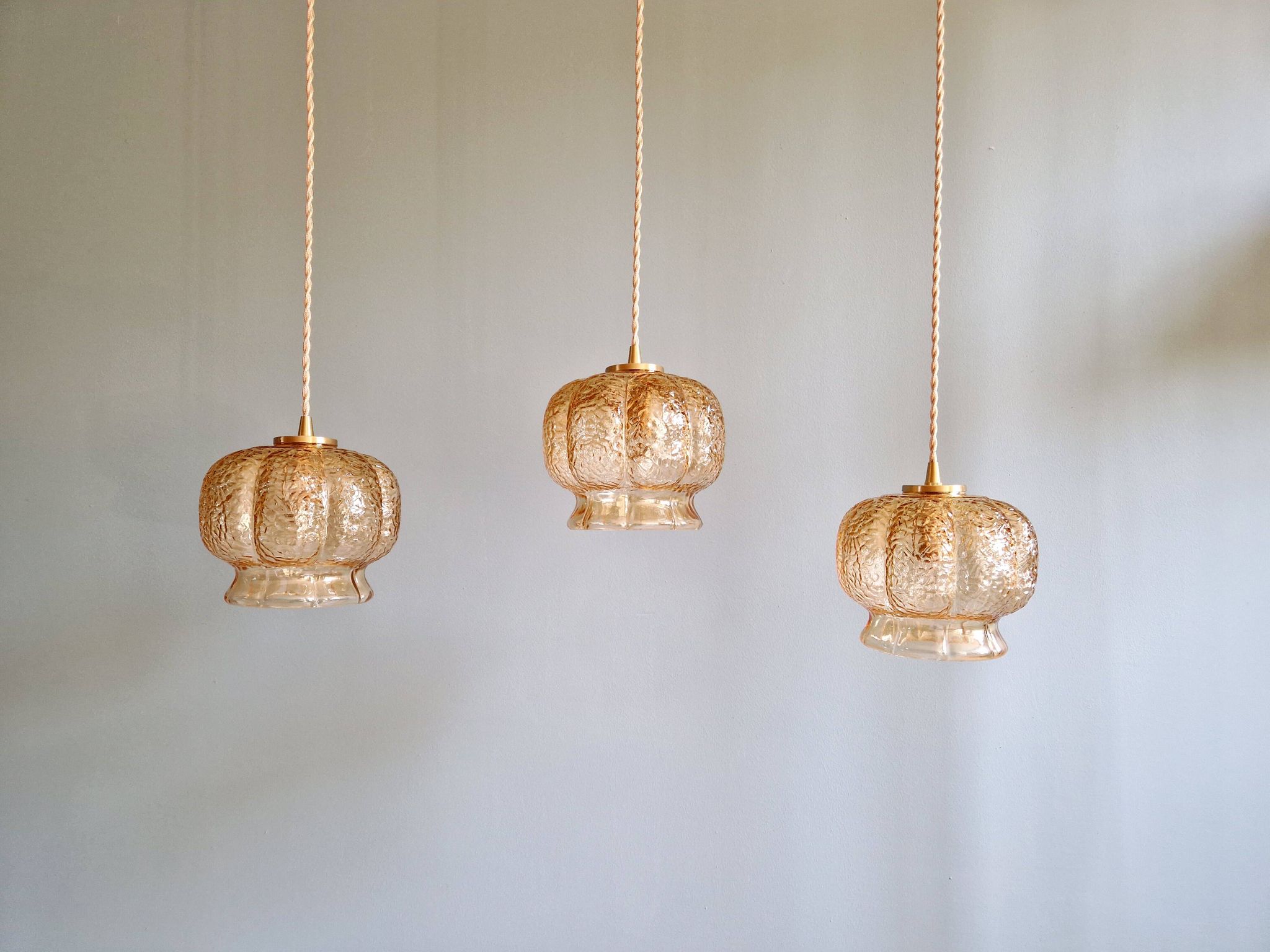 Vintage trio of amber glass pendants, 1960s-70s.