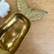 Empty vintage pear-shaped brass pocket
