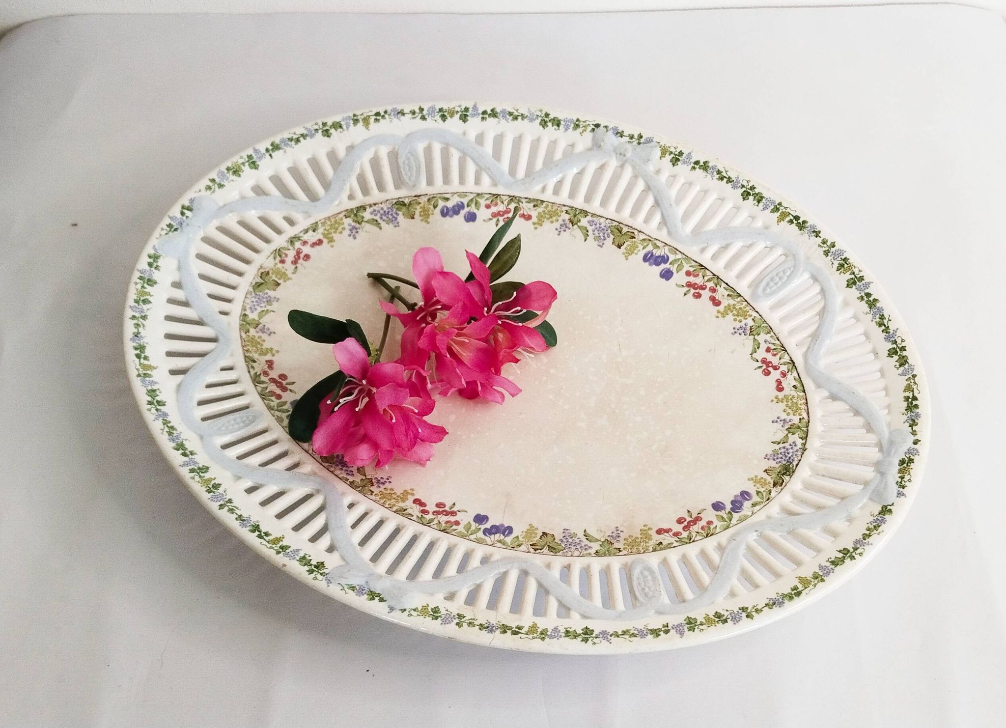 Oval dish in openwork earthenware from Sarreguemines, blue ribbon and fruit