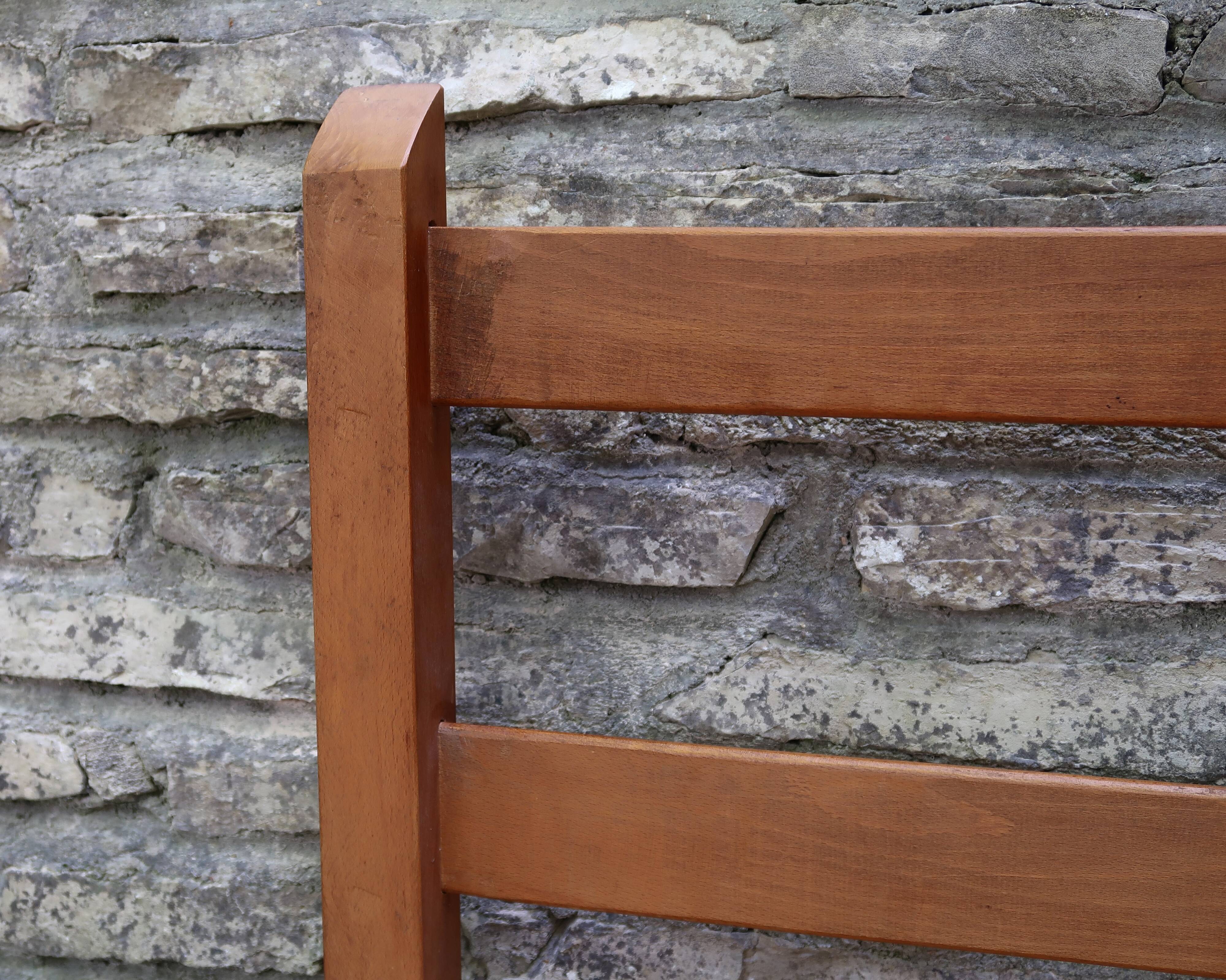 Wooden-backed bench with straw seat, 1970s.