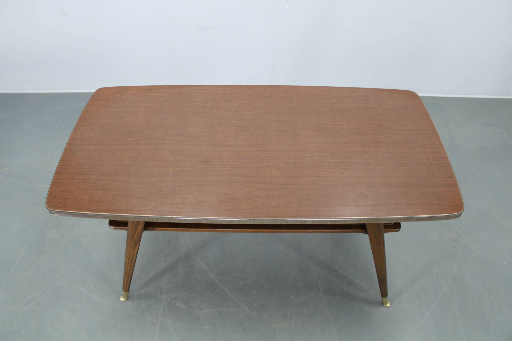 Mid-century German coffee table with rattan shelf and brass legs