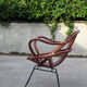 Rattan shell armchair with metal feet