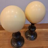 pair of ostrich eggs mounted on a metal base