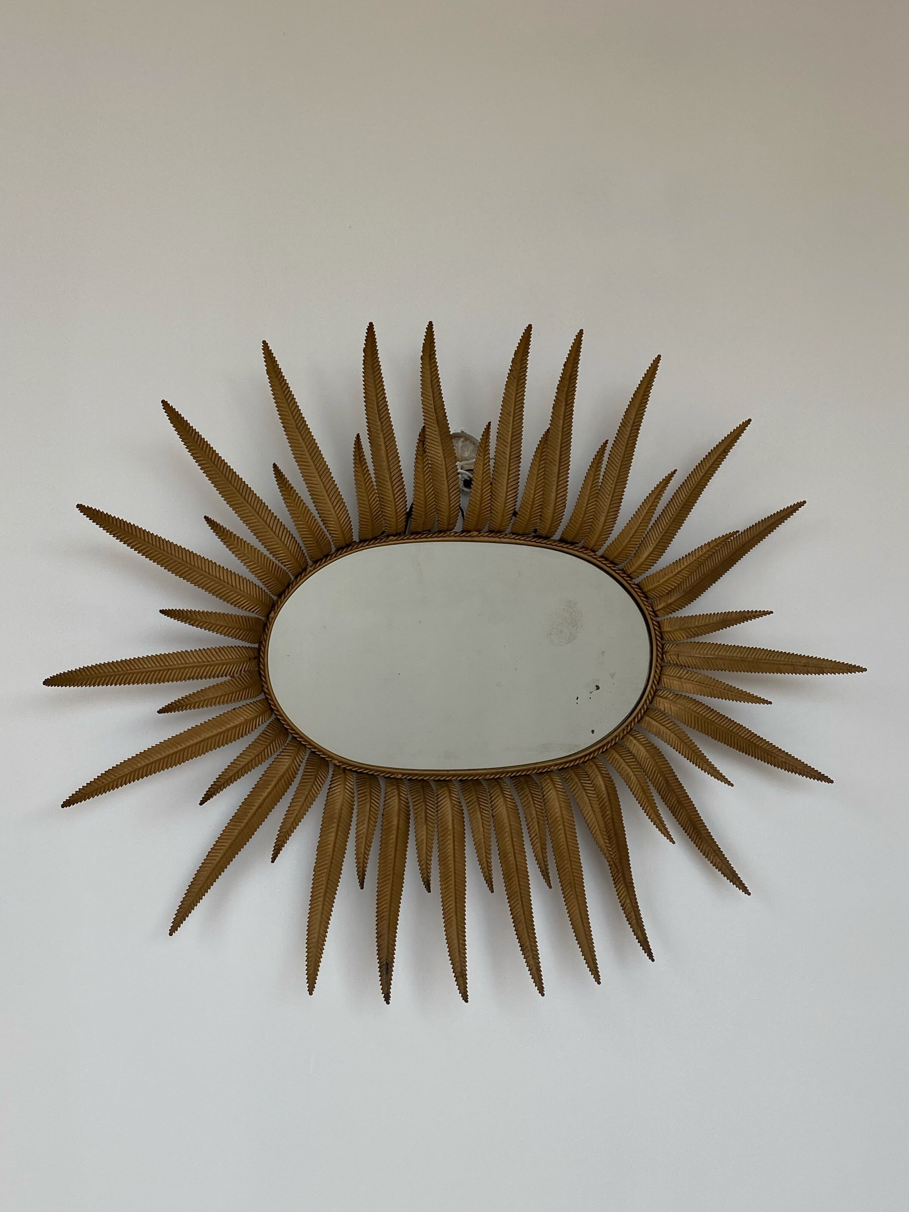 Vintage copper metal sun mirror oval shaped from the 1960s