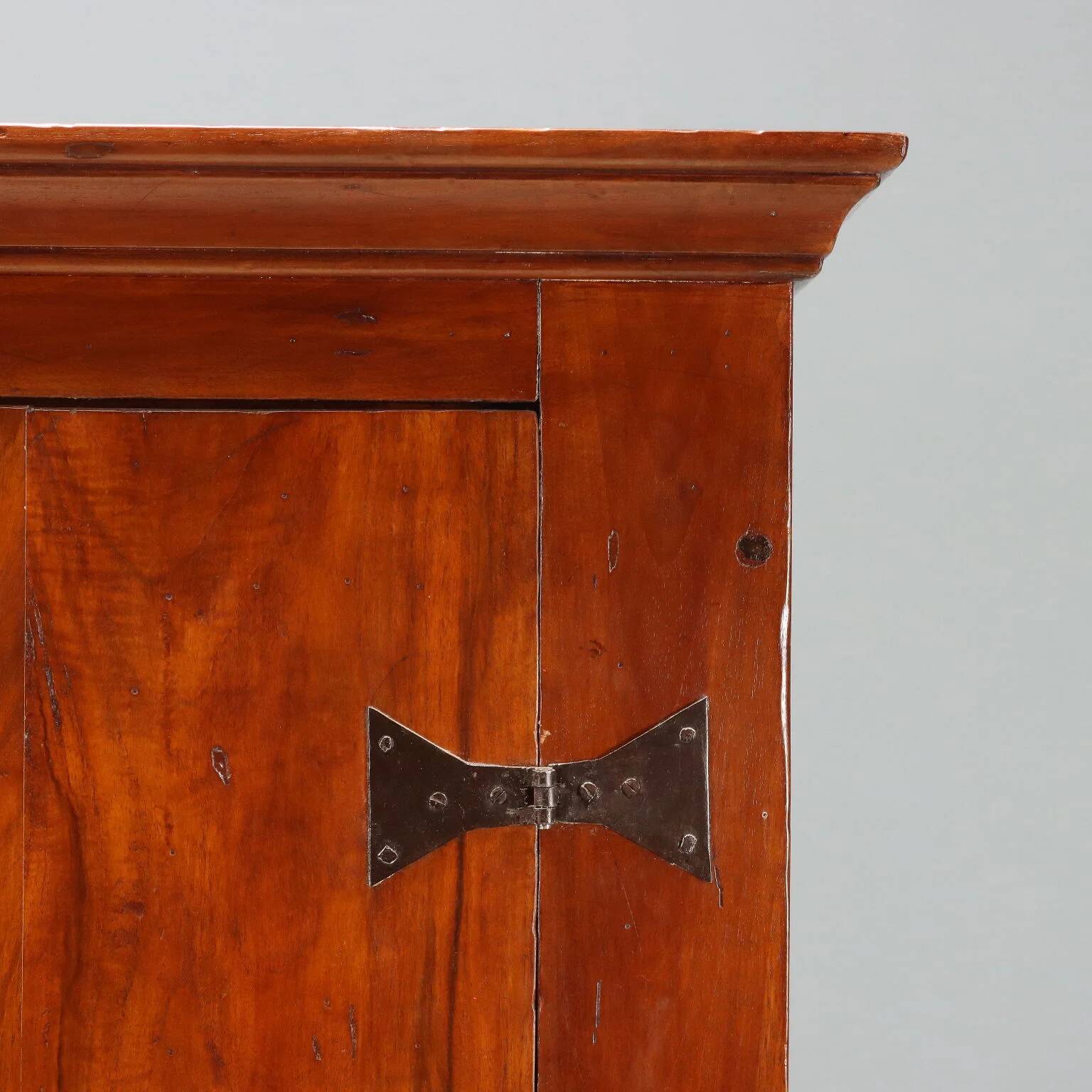 Vintage walnut wardrobe with exposed hardware.