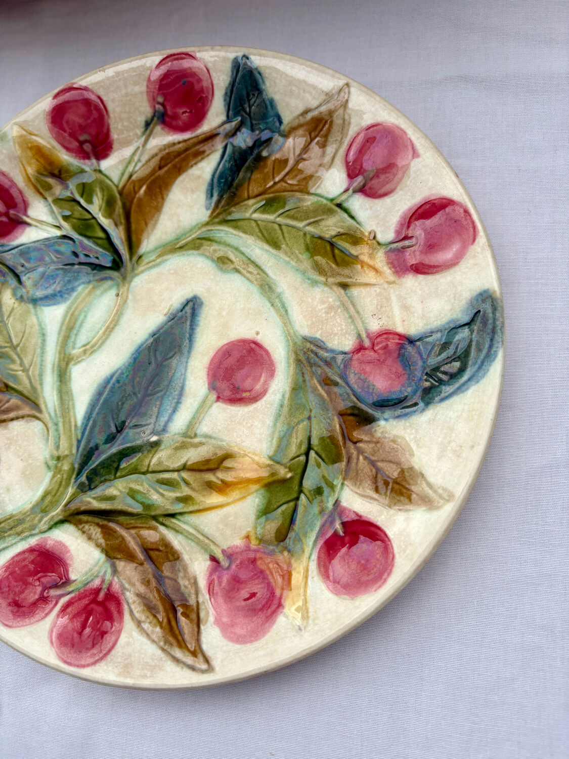 Very old barbotine plate with cherries