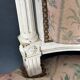 Antique Louis XVI style chair with patinated wood and floral fabric.