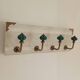 Wall-mounted coat rack in bleached wood and emerald green ceramic hooks –