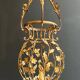 Important golden iron lantern with foliage decorations from the Baguès house.