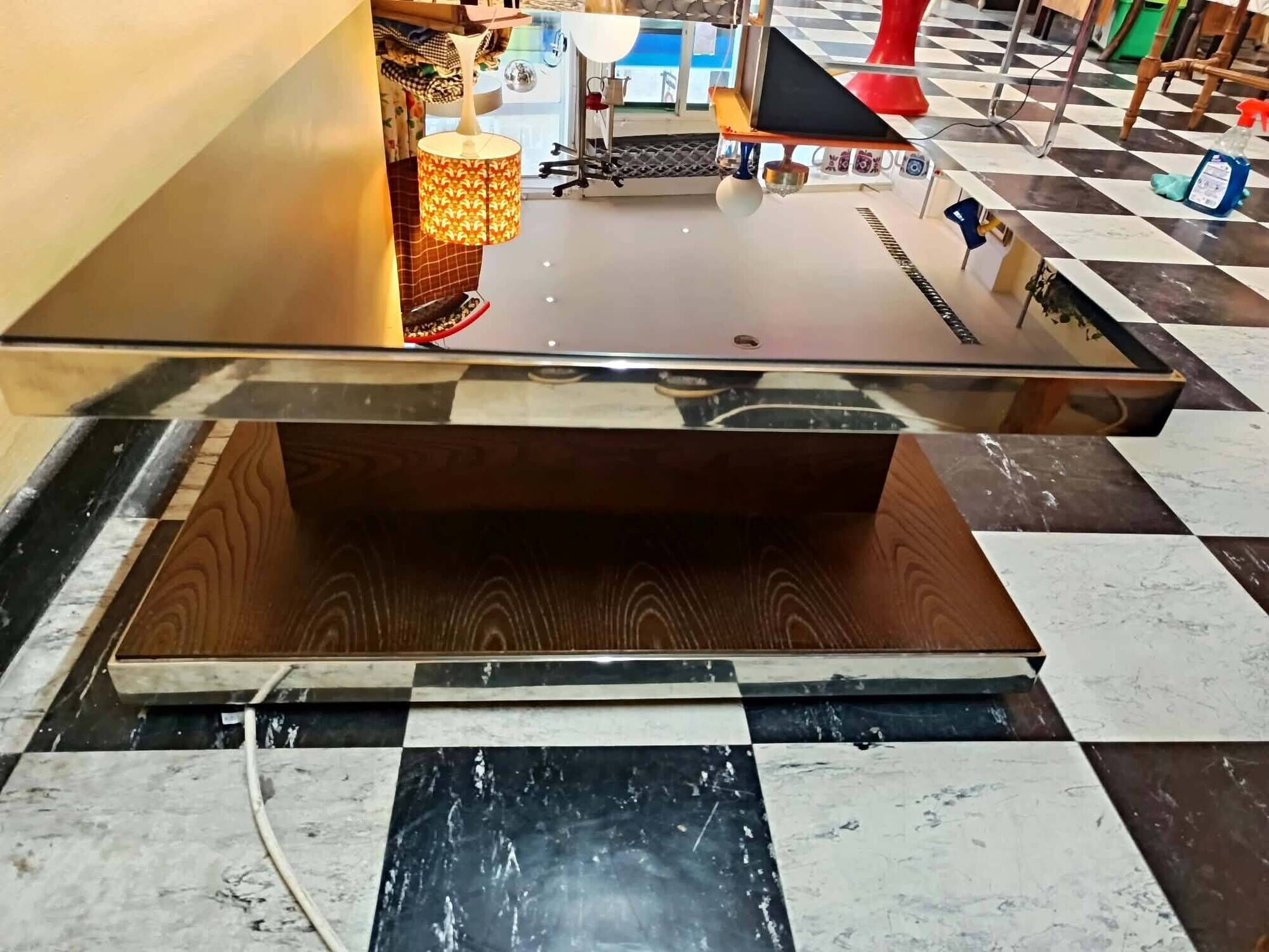 Designer coffee table in glass and chrome metal.
