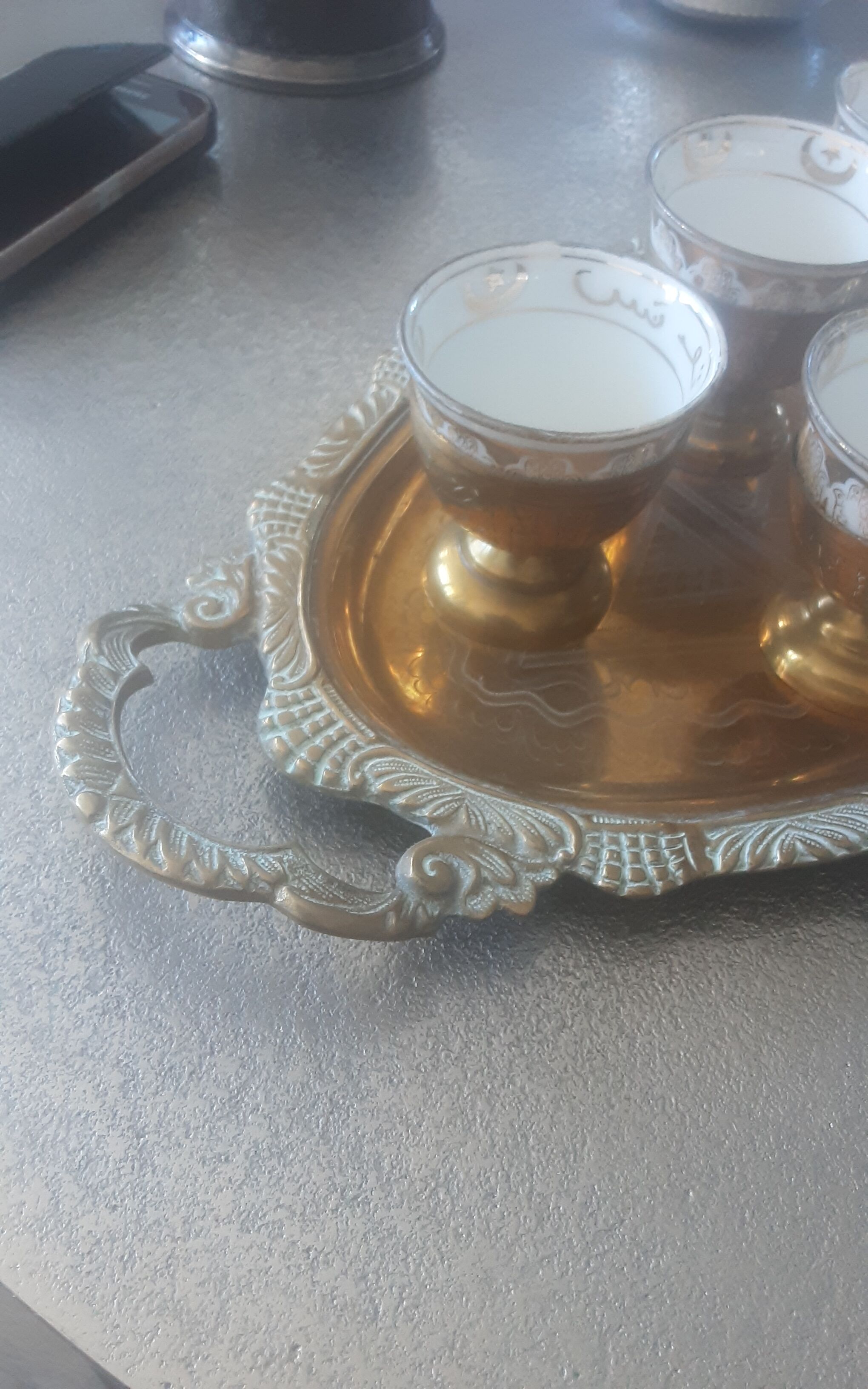 Old service porcelain brass cups