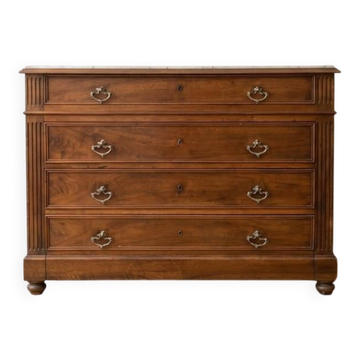 Antique wooden chest of drawers with a marble top.