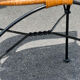 Wicker and black wrought iron armchair