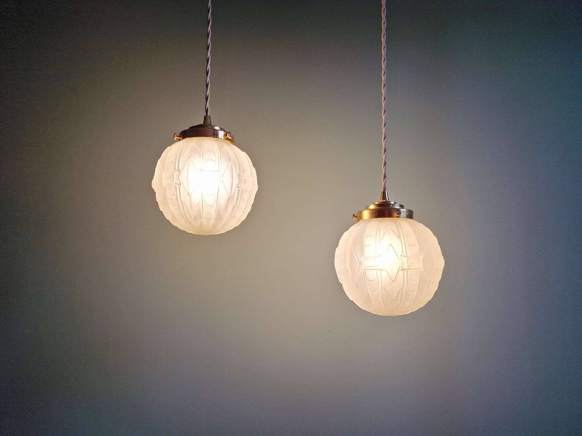 Pair of Art Deco pendant lights in pressed molded satin glass, 1920-30