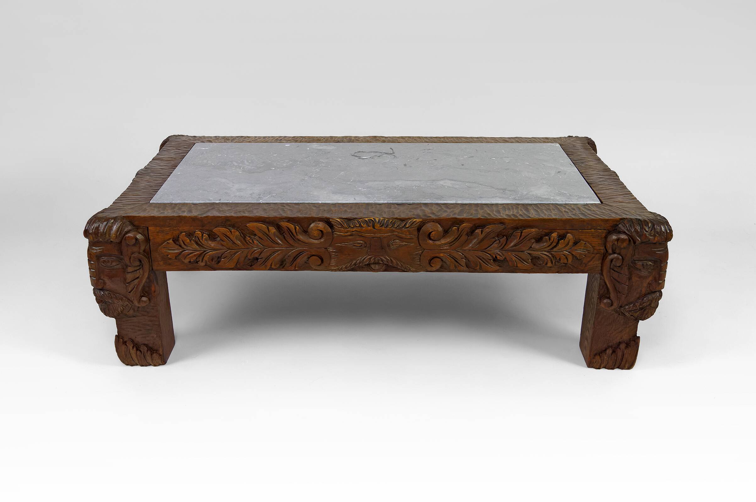 Solid oak coffee table carved with fauns and gray marble top, France, circa 1940