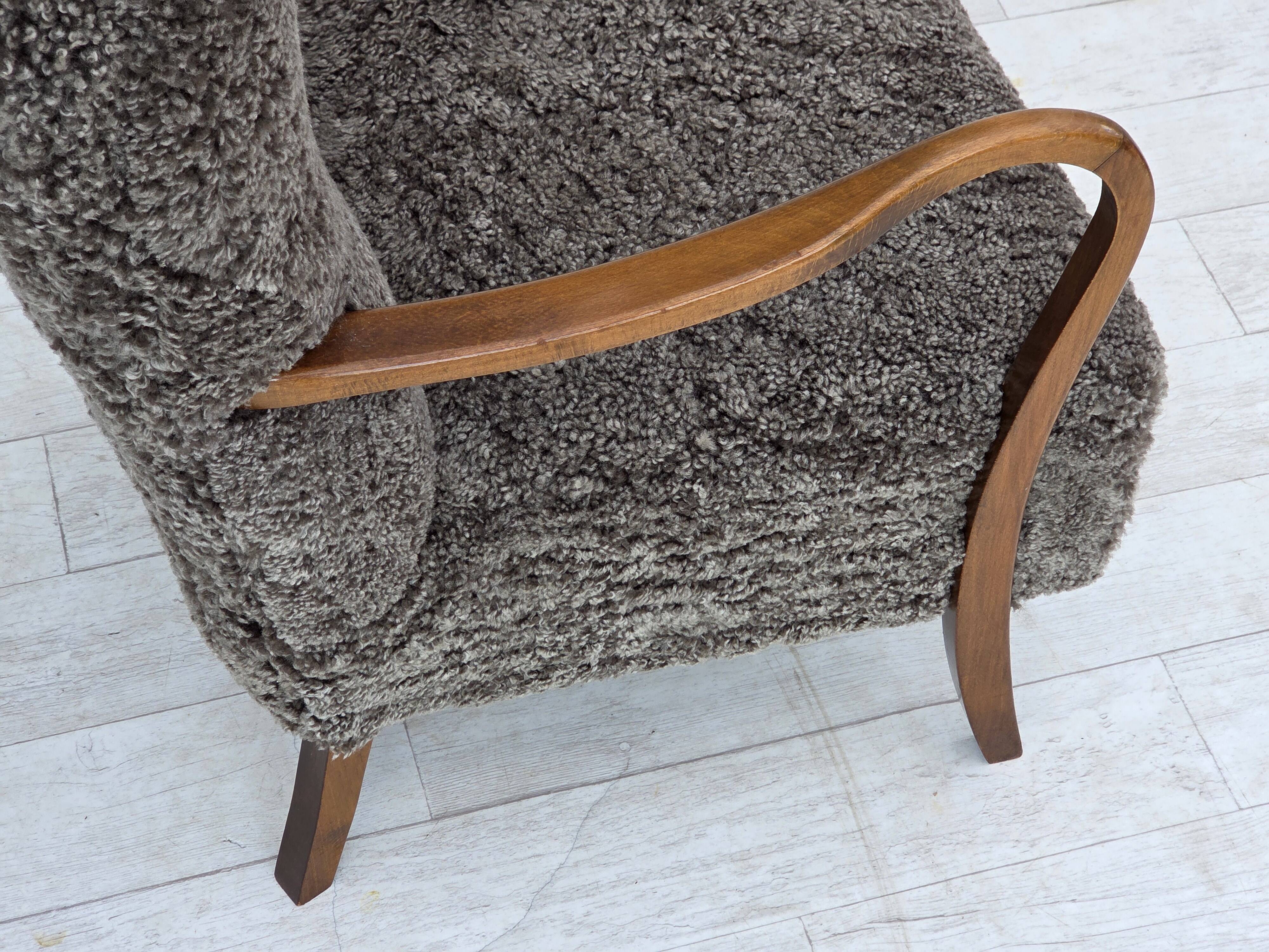 1960s, reupholstered Danish armchair, with stool, genuine sheepskin.