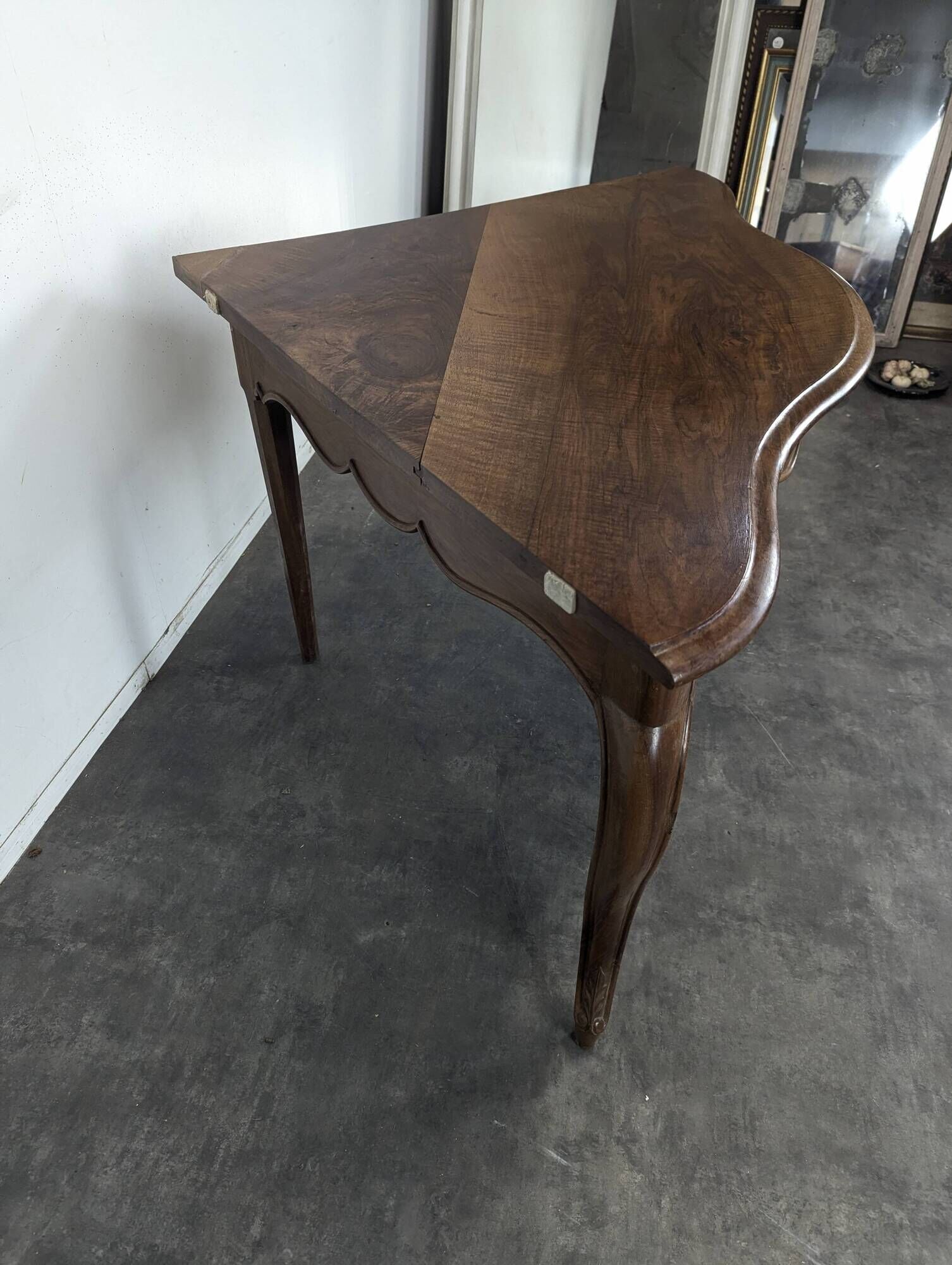 Louis XV corner table in walnut with curved legs.
