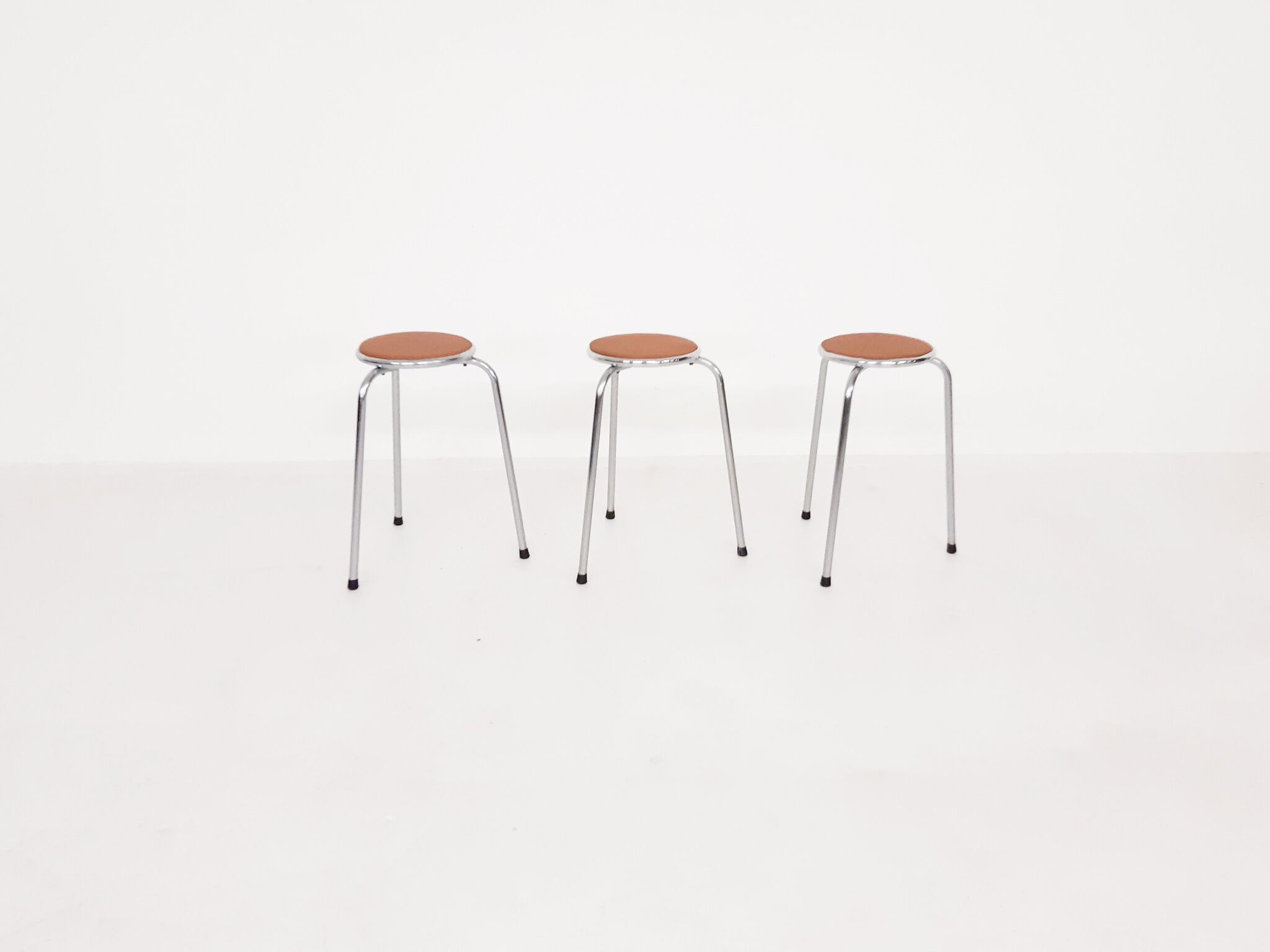 Set of 3 chrome stools with cognac leather seating, 1960's