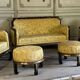 A set of two armchairs, a sofa and two poufs in lacquered wood with gilded chinoiserie decoration.