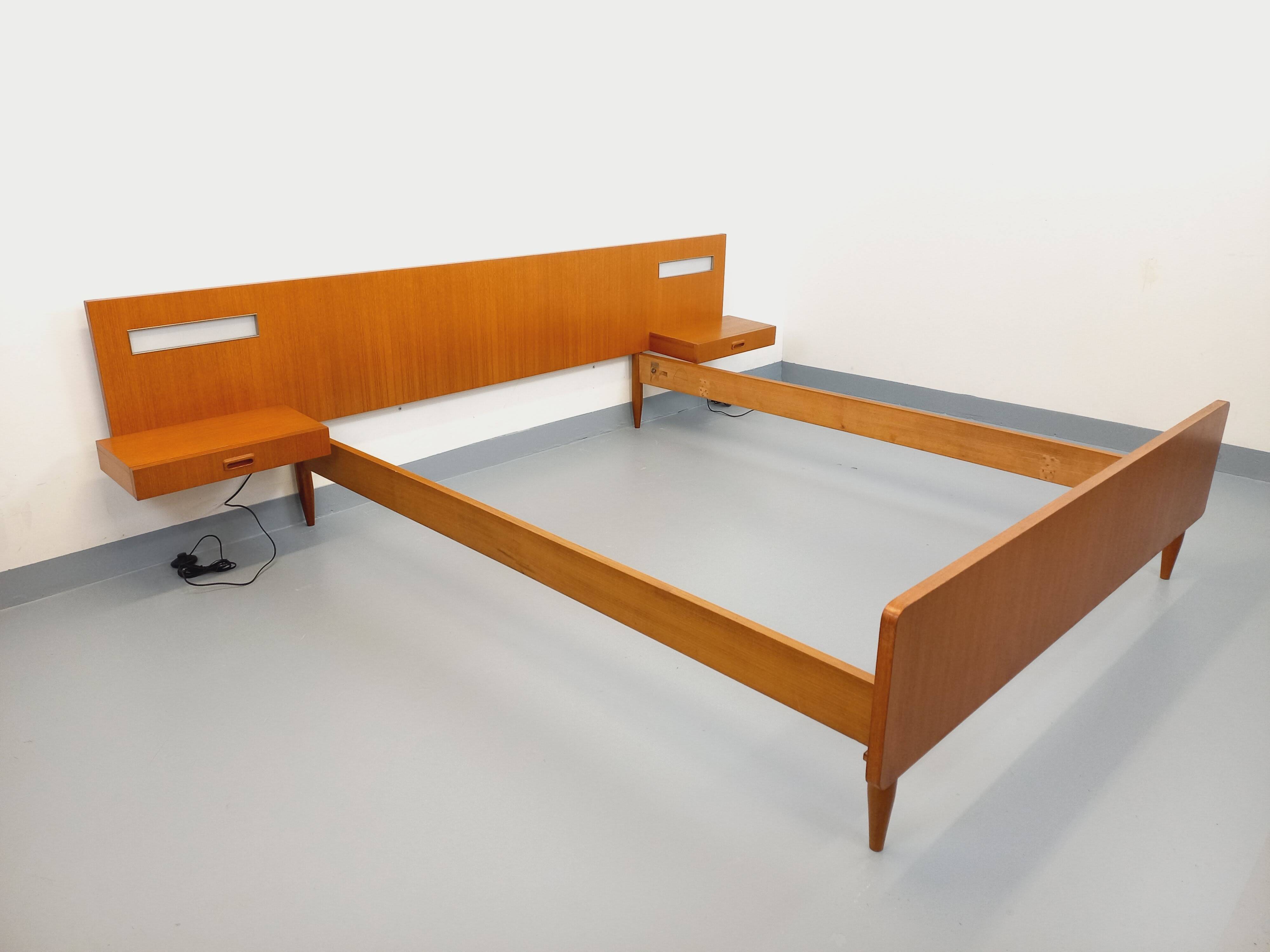 Double bed in vintage Scandinavian style from the 1960s with bedside tables.