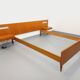 Double bed in vintage Scandinavian style from the 1960s with bedside tables.