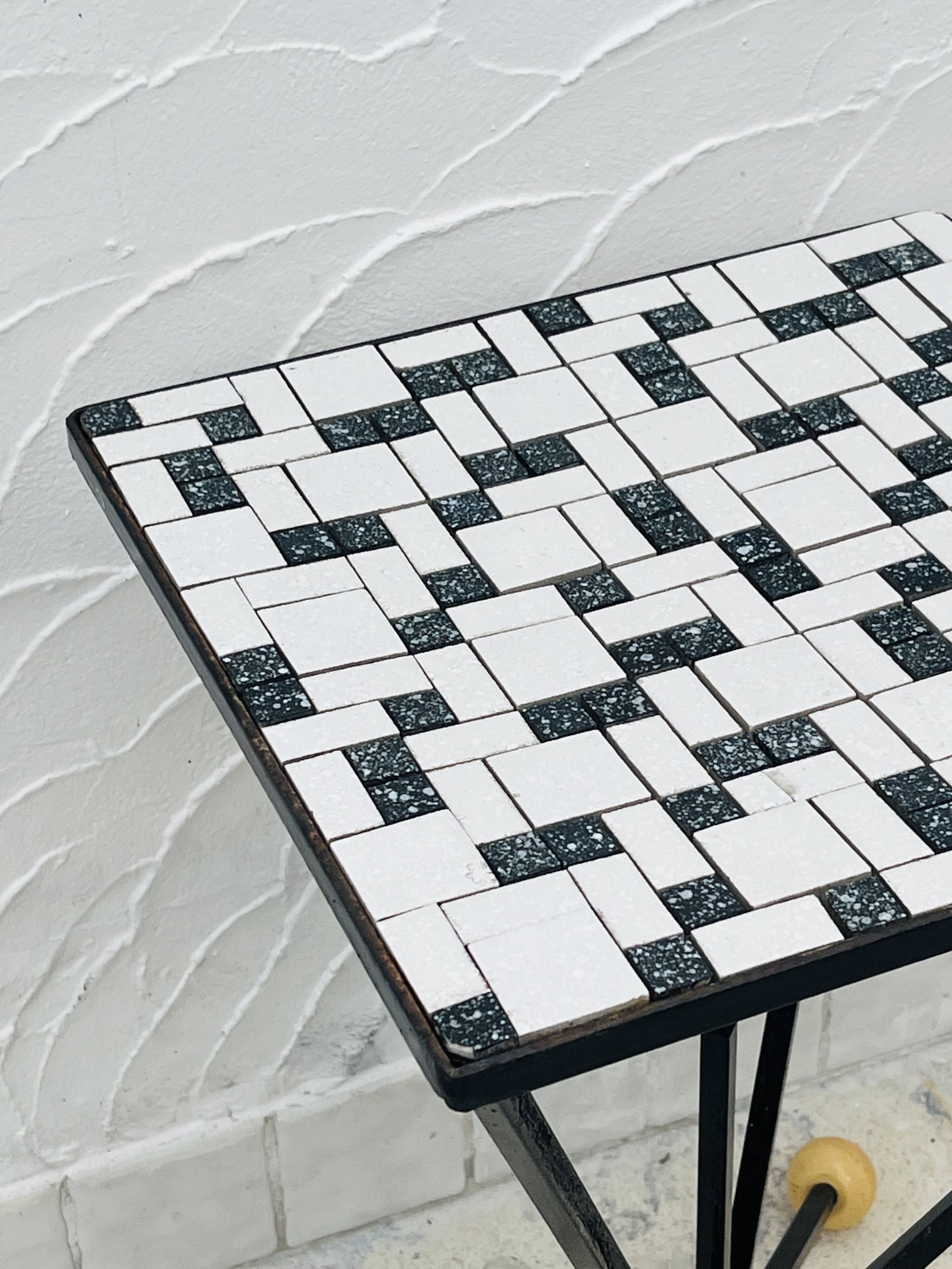 Wrought iron stela and black and white tiled top from the 1960s.