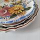 Set of three earthenware plates from Bassano, hand-painted with fruit and flower designs.