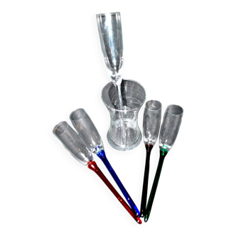 Set of 5 vintage colored glass champagne flutes gathered in a bouquet in a vase
