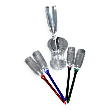 Set of 5 vintage colored glass champagne flutes gathered in a bouquet in a vase