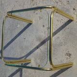 Nested tubular tables in gold metal.