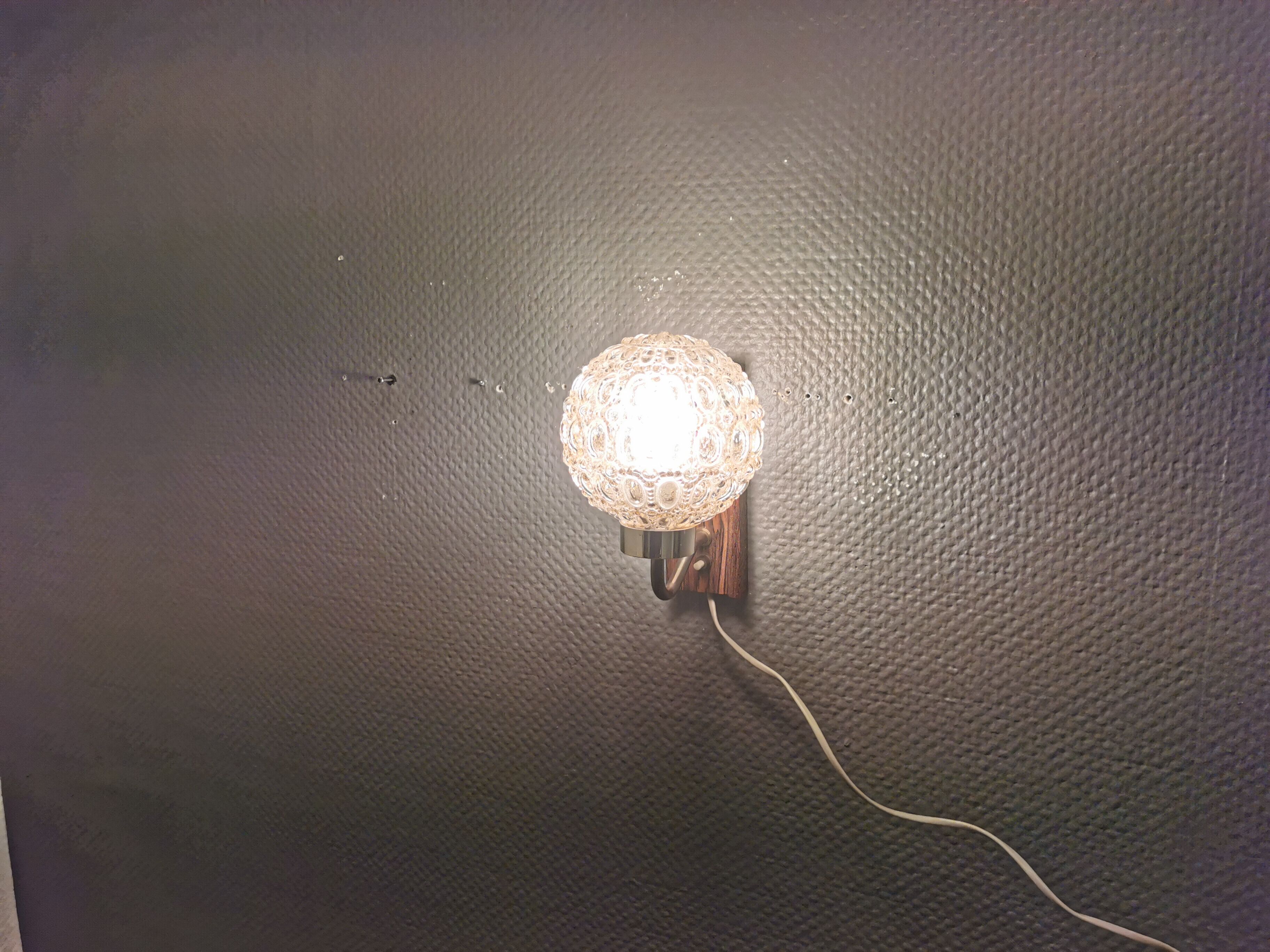 Wall light in rosewood with bobble glass ball shade.
