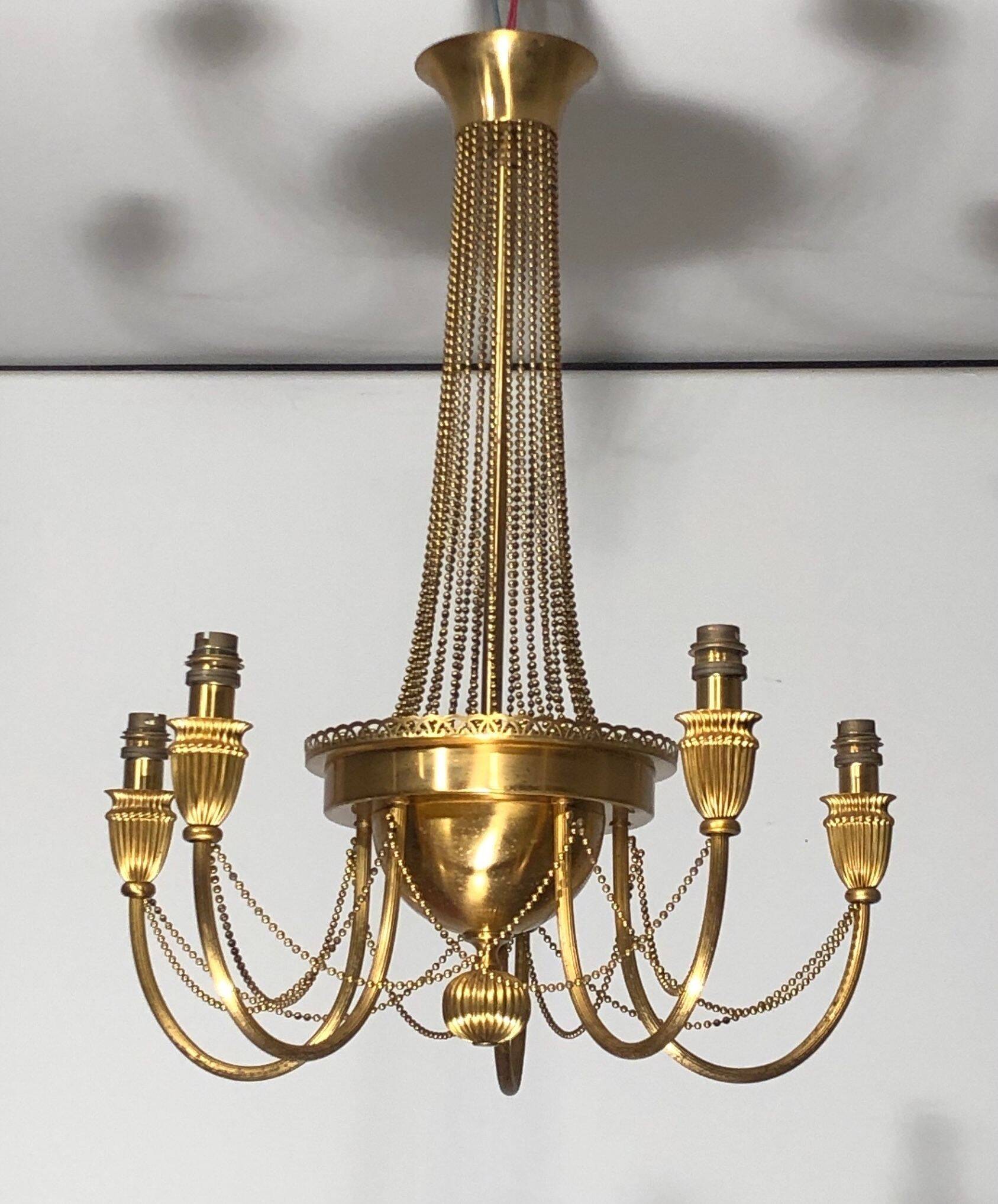 Neoclassical style brass chandelier decorated with pearl garlands