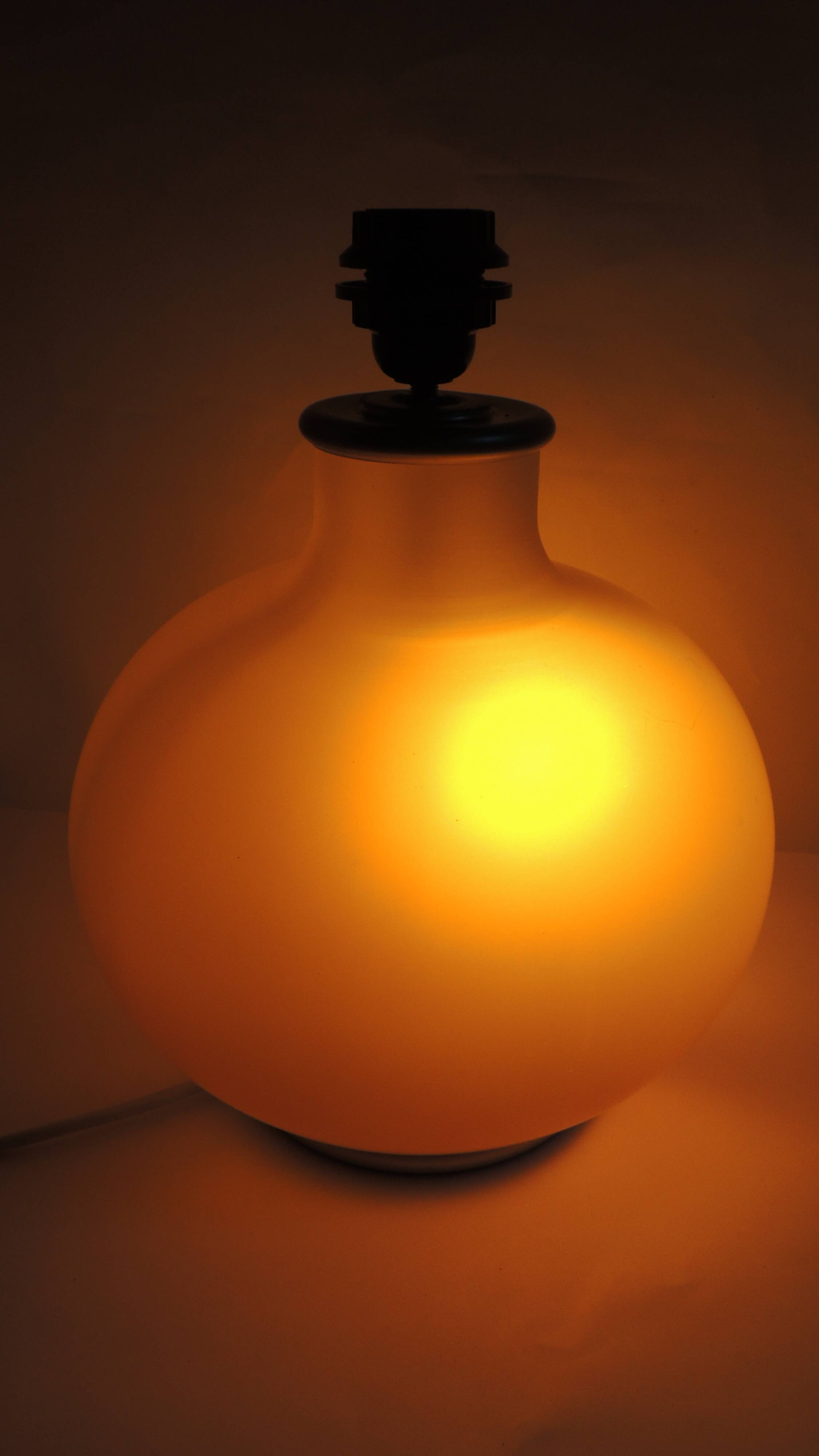 Vintage frosted glass lamp, round globe, elegant design, soft light.
