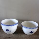 A set of two Digoin earthenware cups with blue, red, and yellow flowers.