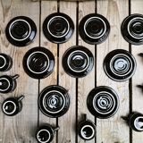 Set of 9 cups and sub-cups in black ceramic and colored gold border