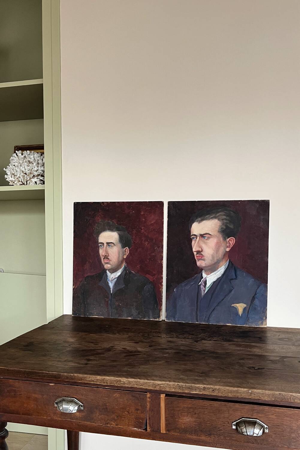 Old oil painting on cardboard portrait of a man in a dark suit